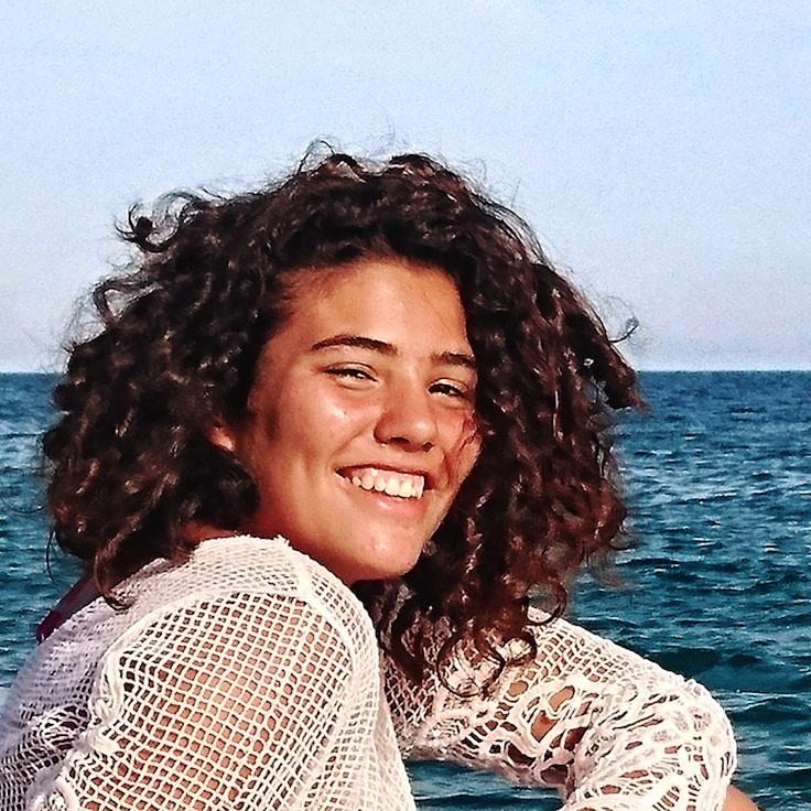 Kaveri Mehta, Lead Design Curator at Gallery Stone Park, reviewing corporate floral arrangements